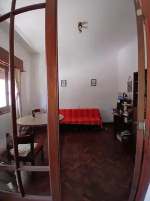 a living room with a red bed in a room at Casa Corna in Río Cuarto