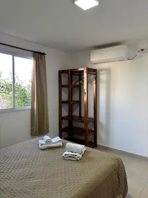 a bedroom with a bed with two towels on it at Complejo Alto Paraiso in Villa Cura Brochero