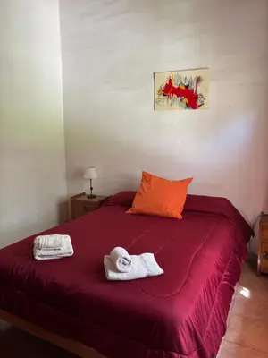 a bedroom with a bed with towels on it at Complejo Alto Paraiso in Villa Cura Brochero