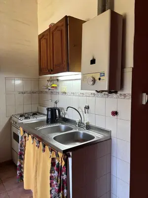 a kitchen with a sink and a stove at Complejo Alto Paraiso in Villa Cura Brochero