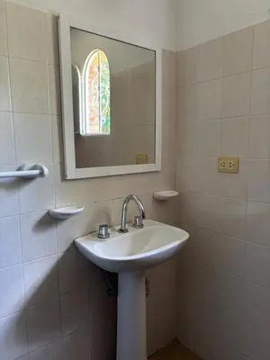 a bathroom with a sink and a mirror at Complejo Alto Paraiso in Villa Cura Brochero