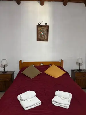 a bedroom with a bed with two towels on it at Complejo Alto Paraiso in Villa Cura Brochero