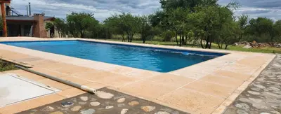 a swimming pool in a yard with a hose at Aire de montaña in Quebrada de los Pozos