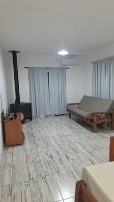 an empty room with a bed and a stove in it at Casa en Merlo in Cañada La Negra