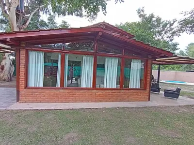 a small house with a red brick at Complejo LA ADELAIDA in Mina Clavero