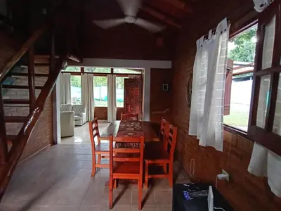 a dining room with a wooden table and chairs at Complejo LA ADELAIDA in Mina Clavero