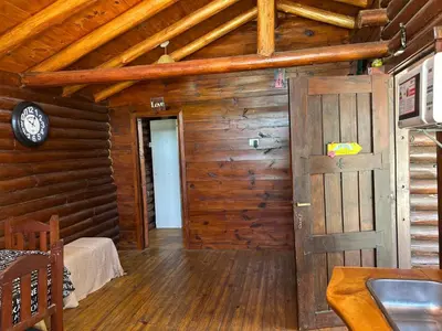 a room with a door in a log cabin at Cabaña con pileta en Villa Carlos Paz in Villa Carlos Paz
