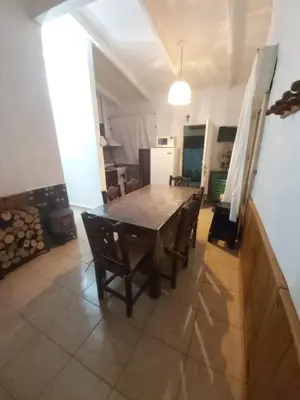 a dining room with a table and chairs at Cabaña - casa - chalet con pileta a minutos de Villa Carlos Paz para 8 personas in San Roque