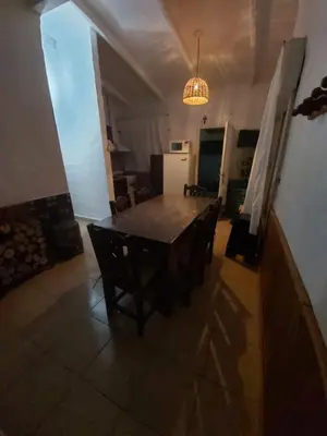 a dining room with a table and chairs at Cabaña - casa - chalet con pileta a minutos de Villa Carlos Paz para 8 personas in San Roque
