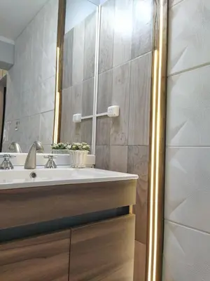 a bathroom with a sink and a mirror at Departamento de los Cuadros in Villa Carlos Paz