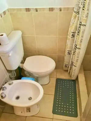 a small bathroom with a toilet and a sink at Hogar Serrano in Villa de Las Rosas