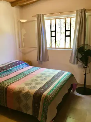 a bedroom with a bed and a window at Hogar Serrano in Villa de Las Rosas
