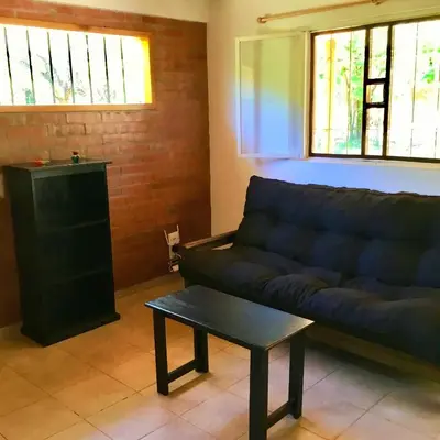 a living room with a couch and a table at Hogar Serrano in Villa de Las Rosas