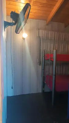 a room with a bed and a light and a window at Depto en planta alta in Villa Carlos Paz