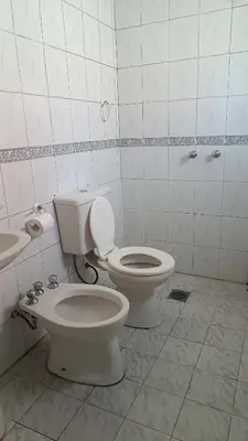 a bathroom with a toilet and a sink at Depto en planta alta in Villa Carlos Paz