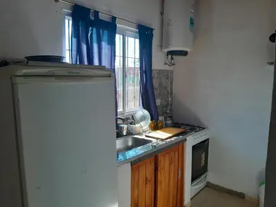 a small kitchen with a sink and a window at Cabañas Margaret in Santa María