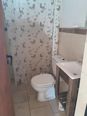 a bathroom with a toilet and a sink at Cabañas Margaret in Santa María
