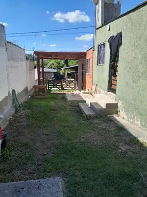 an outside view of a building with a patio at Cabañas Margaret in Santa María