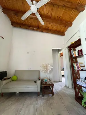 a living room with a couch and a ceiling fan at La Paz in La Paz