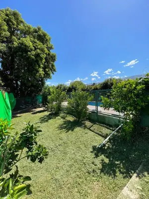 a yard with a fence and trees and grass at La Paz in La Paz
