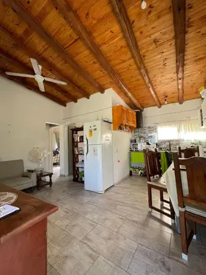 a kitchen with a white refrigerator and wooden ceilings at La Paz in La Paz