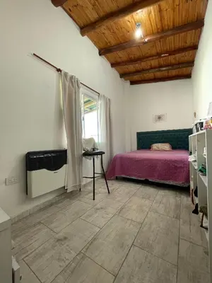 a bedroom with a pink bed and a window at La Paz in La Paz