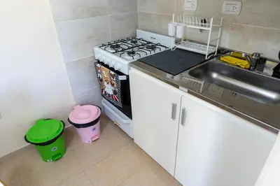 a kitchen with a stove top oven next to a sink at Piedras Moras cabañas in Almafuerte