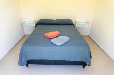 a bed in a room with two towels on it at Piedras Moras cabañas in Almafuerte