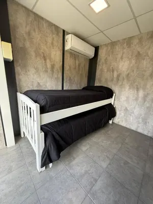 two bunk beds in a room with a heater at Piedras Moras cabañas in Almafuerte