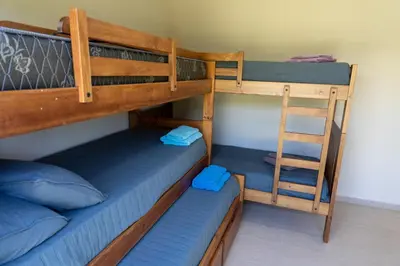 a bedroom with two bunk beds and a ladder at Piedras Moras cabañas in Almafuerte