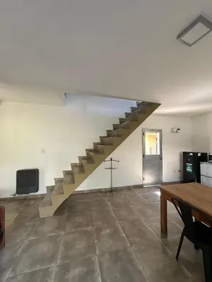 a staircase in an empty room with a table at Loft en Villa belgrano in Cordoba