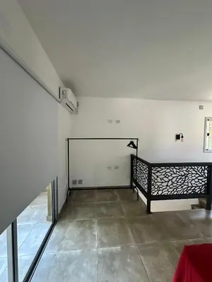 an empty room with a bed in a room at Loft en Villa belgrano in Cordoba