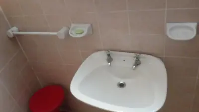a bathroom with a white sink and a red stool at Sierras de Córdoba in Santa María