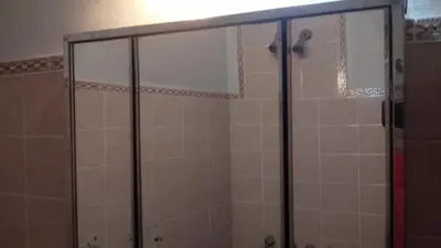 a shower with glass doors in a bathroom at Sierras de Córdoba in Santa María
