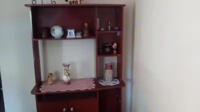 a shelf with vases and other items on it at Sierras de Córdoba in Santa María