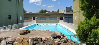 a large swimming pool in the middle of a building at Complejo MIAMI BEACH in Villa Carlos Paz