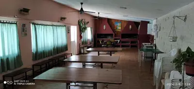 a restaurant with tables and chairs in a room at Complejo MIAMI BEACH in Villa Carlos Paz