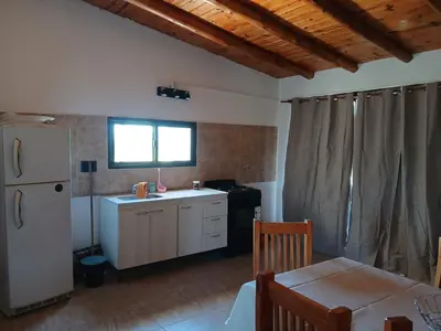 a kitchen with a white refrigerator and a table at La soñada in San Antonio de Arredondo