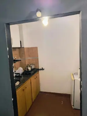 a kitchen with a door open to a kitchen with a counter at San Martin 40 in Villa Carlos Paz