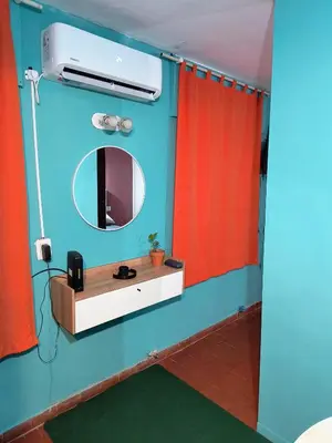a bathroom with a mirror and a sink at San Martin 40 in Villa Carlos Paz