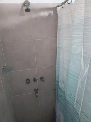 a bathroom with a shower with a shower curtain at San Martin 40 in Villa Carlos Paz