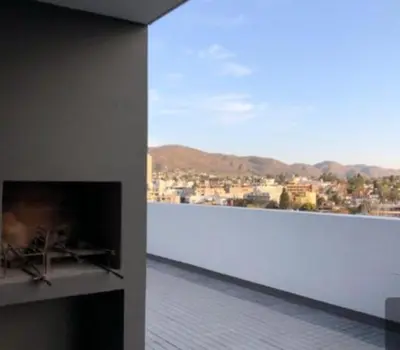 a room with a fireplace with a view of a city at Venetto IV in Cordoba