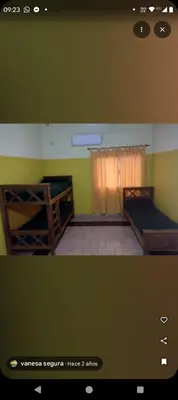 two bunk beds in a room with green walls at Cabañas Los Dos Talas in Barrio Parque El Corcovado