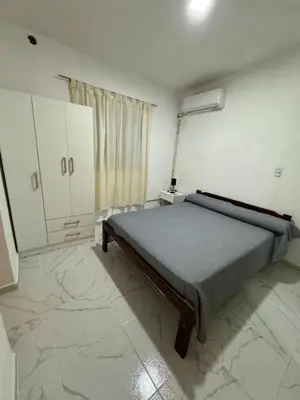 a bedroom with a bed in a room with marble floors at PEPINA Villa Cura Brochero in Villa Cura Brochero
