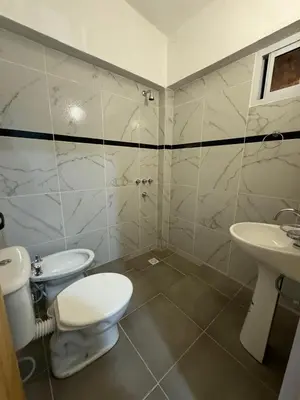 a bathroom with a toilet and a sink at PEPINA Villa Cura Brochero in Villa Cura Brochero