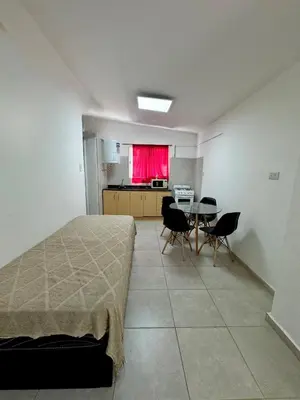 a room with a bed and a table with chairs at PEPINA Villa Cura Brochero in Villa Cura Brochero