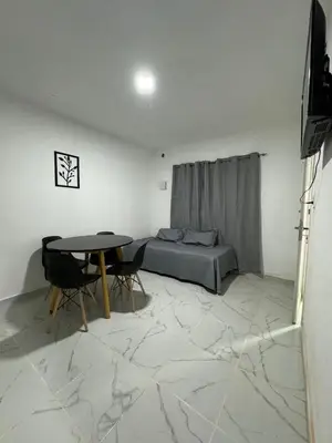 a living room with a bed and a table at PEPINA Villa Cura Brochero in Villa Cura Brochero