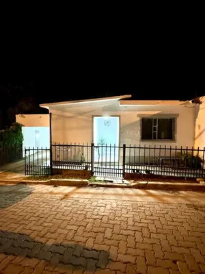 a white building with a fence in front of it at PEPINA Villa Cura Brochero in Villa Cura Brochero