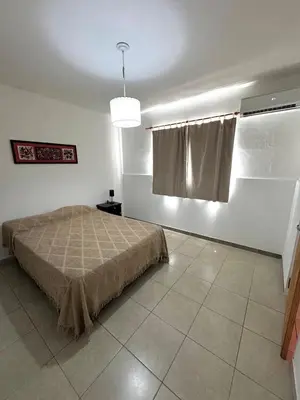 a bedroom with a bed in a room with a window at PEPINA Villa Cura Brochero in Villa Cura Brochero
