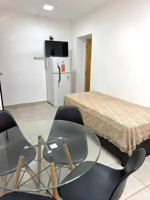 a room with a table and chairs and a bed at PEPINA Villa Cura Brochero in Villa Cura Brochero
